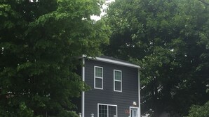 A two-story house with a front porch and a white railing. - 411 S. Madison Avenue (Watkins Glen)