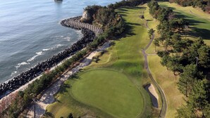 A coastal golf course with a clear view of the ocean and a rocky outcrop. - ONAHAMA OCEAN HOTEL & GOLF CLUB (Iwaki)