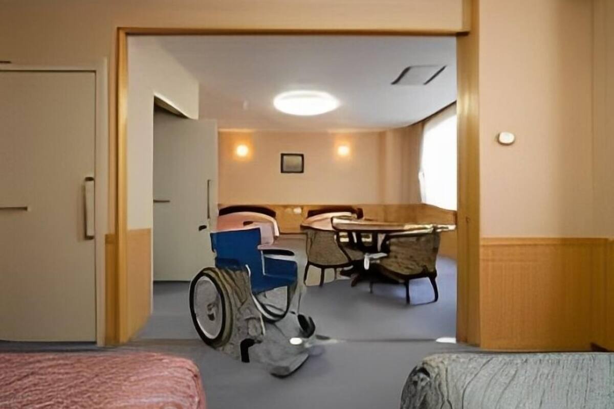 A wheelchair-accessible room with a dining area and a separate sleeping area.