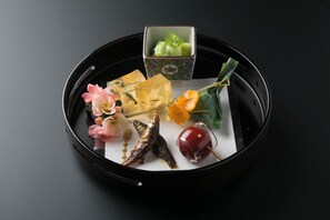 A tray with various food items and a small box.