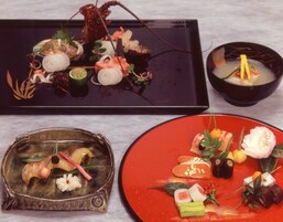 A table with three dishes, each with various food items and garnishes.