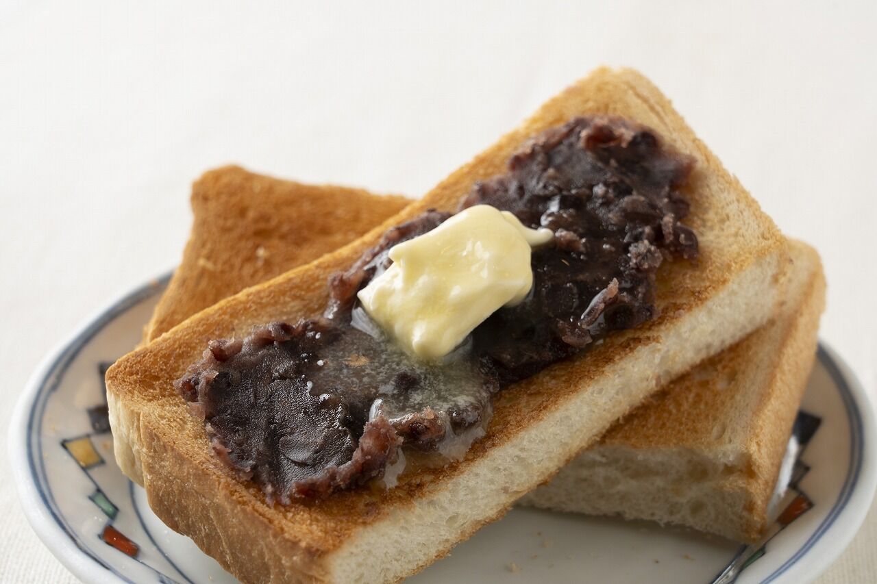 Two slices of toast with a spread on a plate.