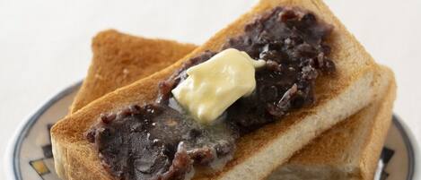 Two slices of toast with a spread on a plate.