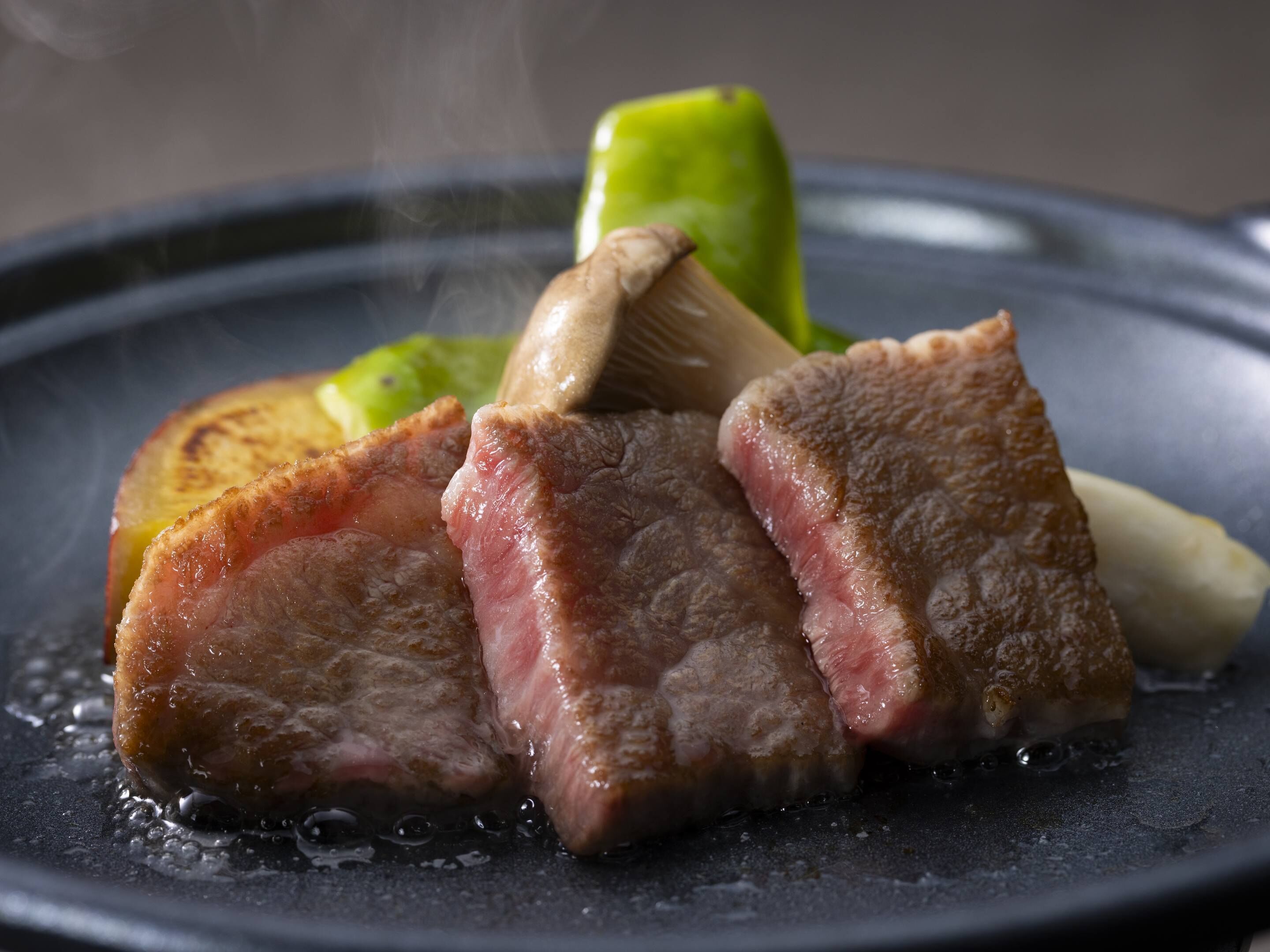 A plate with slices of meat and vegetables.