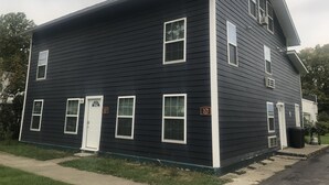 A two-story building with a dark exterior and white trim around windows and doors. - 304 3rd Street, Suite A (Watkins Glen)