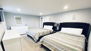A bedroom with two beds, a dresser, and a mirror. - 304 3rd Street, Suite A (Watkins Glen)