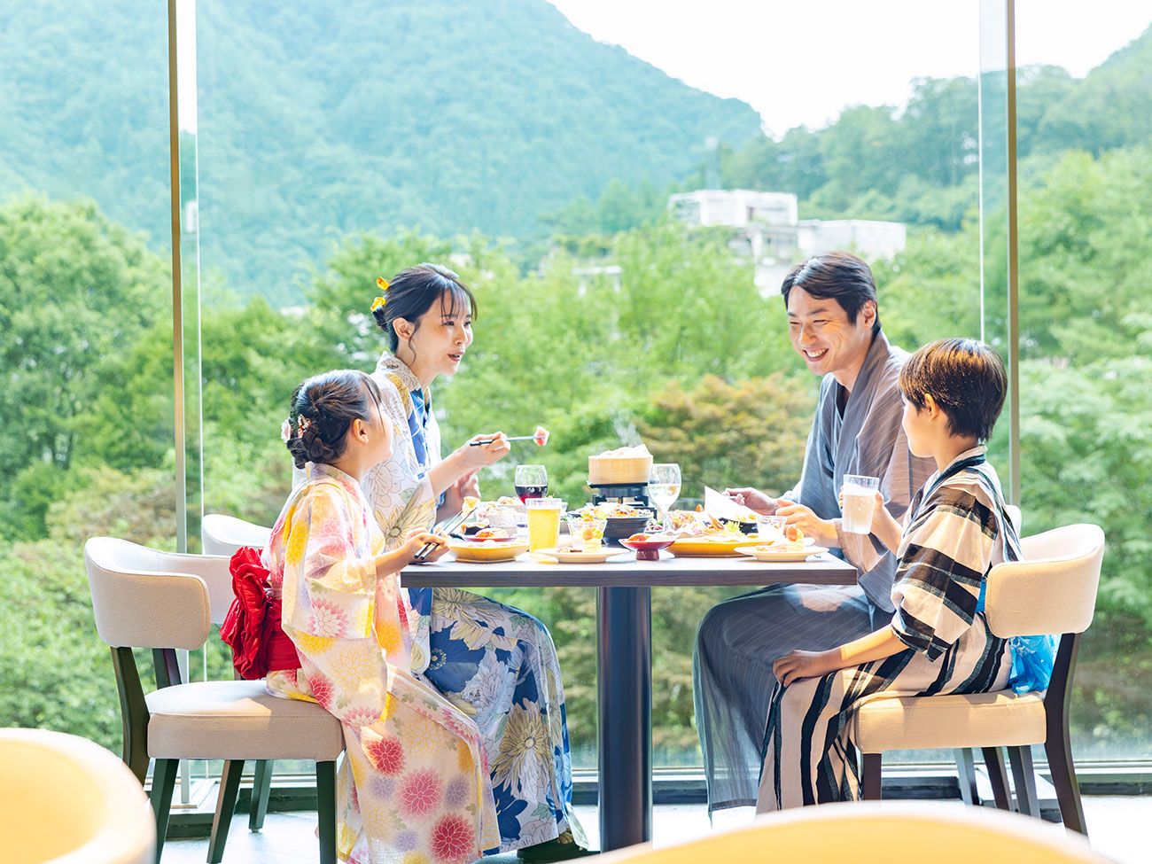 A dining table with a view of a mountainous landscape.