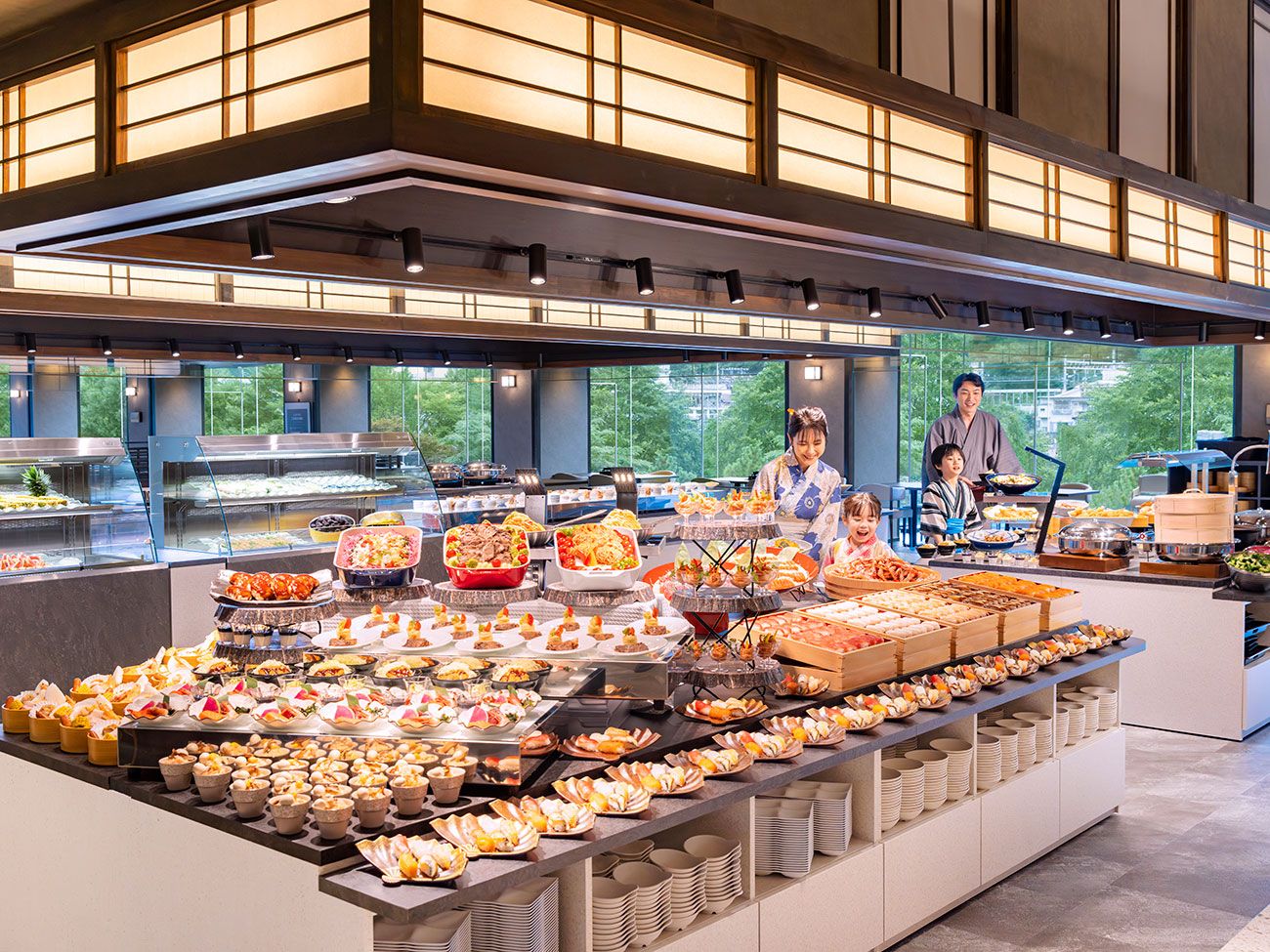A buffet with various food items and a large window in the background.