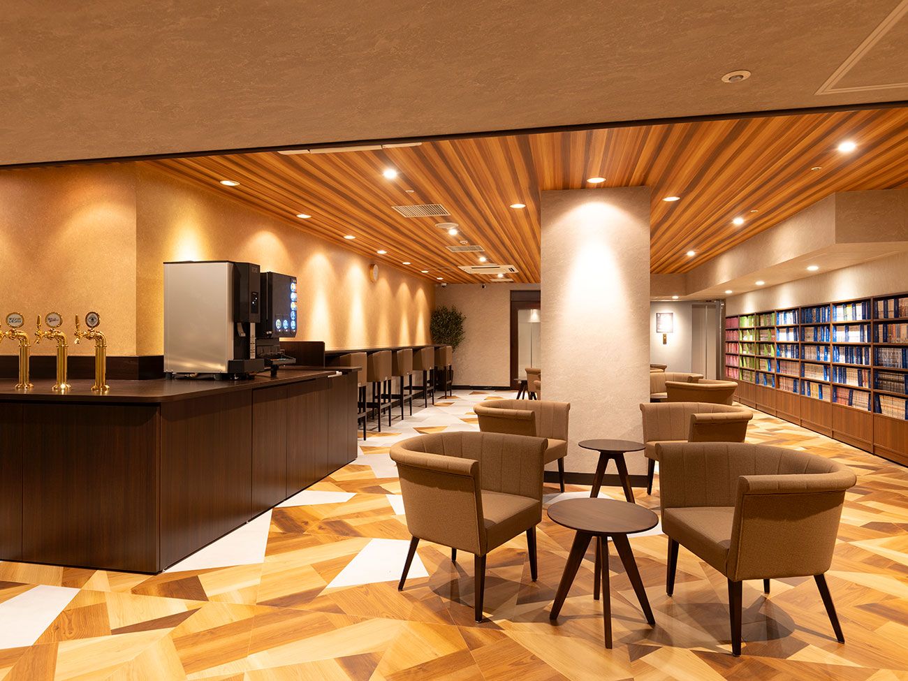 A lobby with a reception desk, seating area, and a bookshelf.