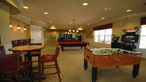 A room with a pool table, foosball table, and a bar area with chairs. - Universal,Disney World,Convention Center,Executive Luxury 5*Vista Cay Villa/Pool (Orlando)