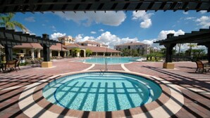 A pool area with a circular design, surrounded by a brick walkway and shaded by pergolas. - Universal,Disney World,Convention Center,Executive Luxury 5*Vista Cay Villa/Pool (Orlando)