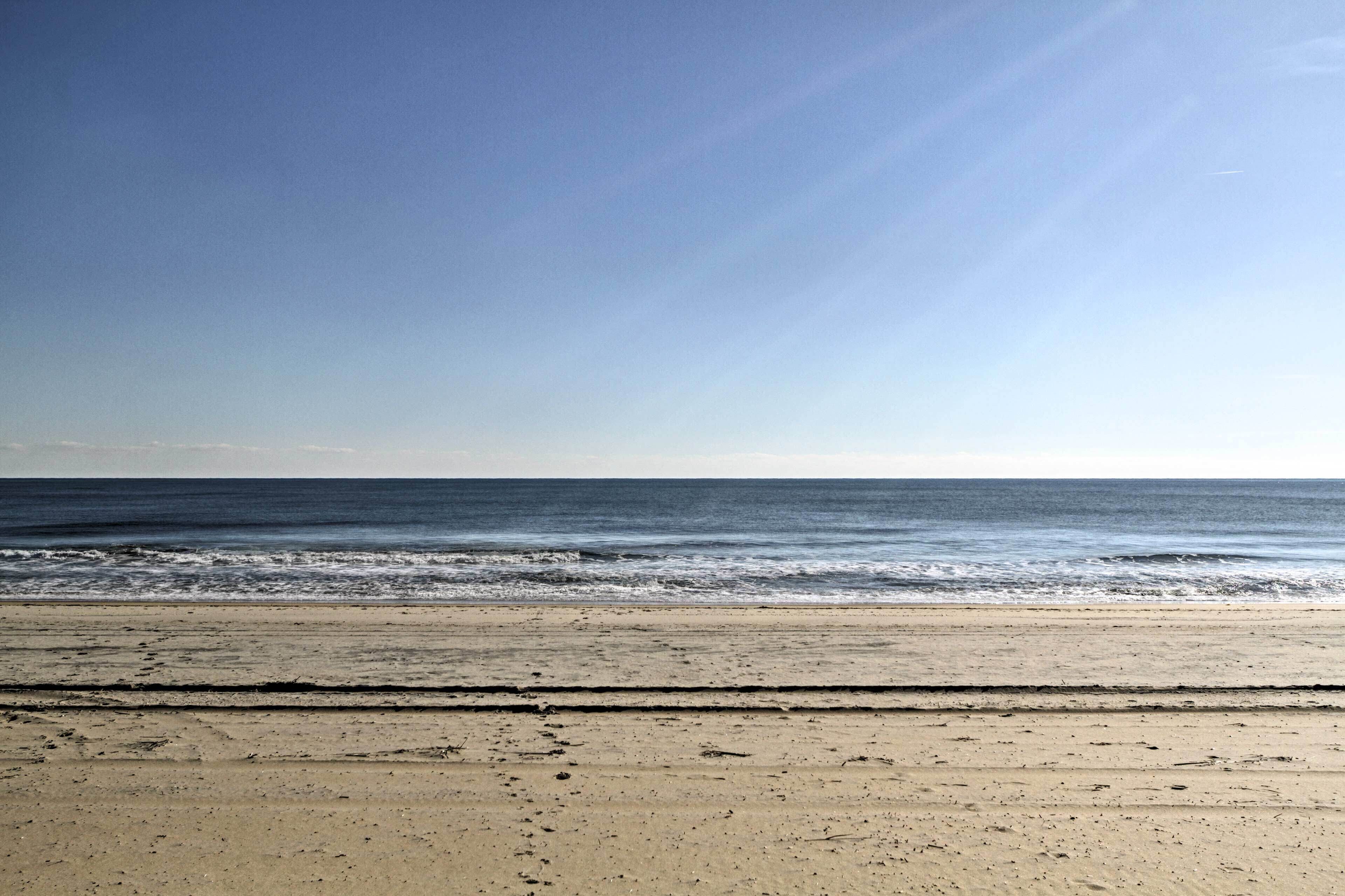 A beach with a clear sky and calm sea.
