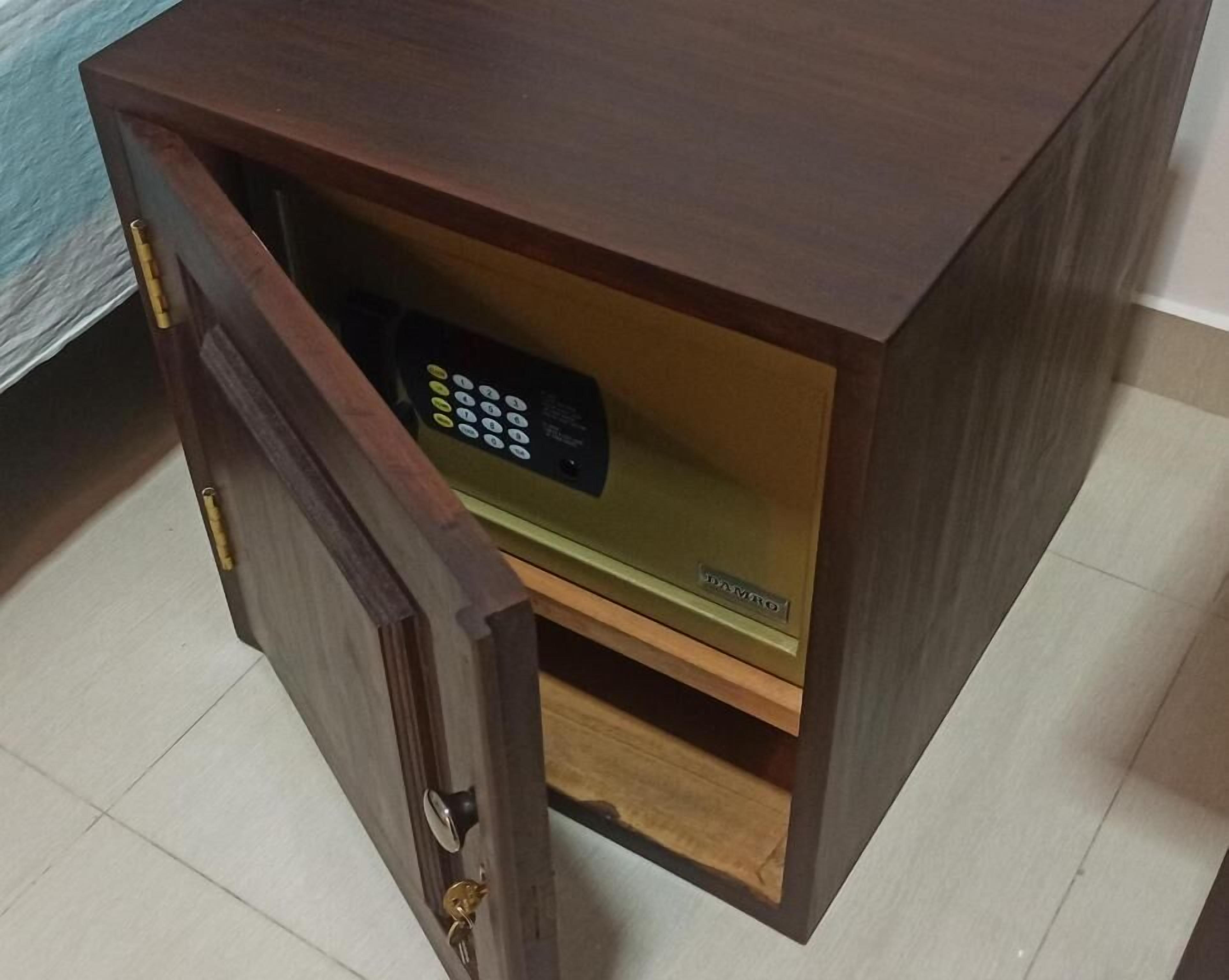 A wooden cabinet with a built-in safe.