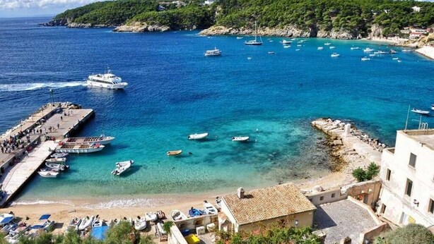 A coastal town with a marina, boats, and a beach. - Blue apartment (Rodi Garganico)
