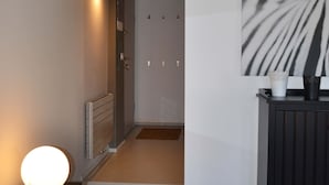 A modern interior with a staircase, a radiator, a lamp, and a piece of abstract art. - NEW APARTMENT in the heart of Citta 'Alta (Bergamo)