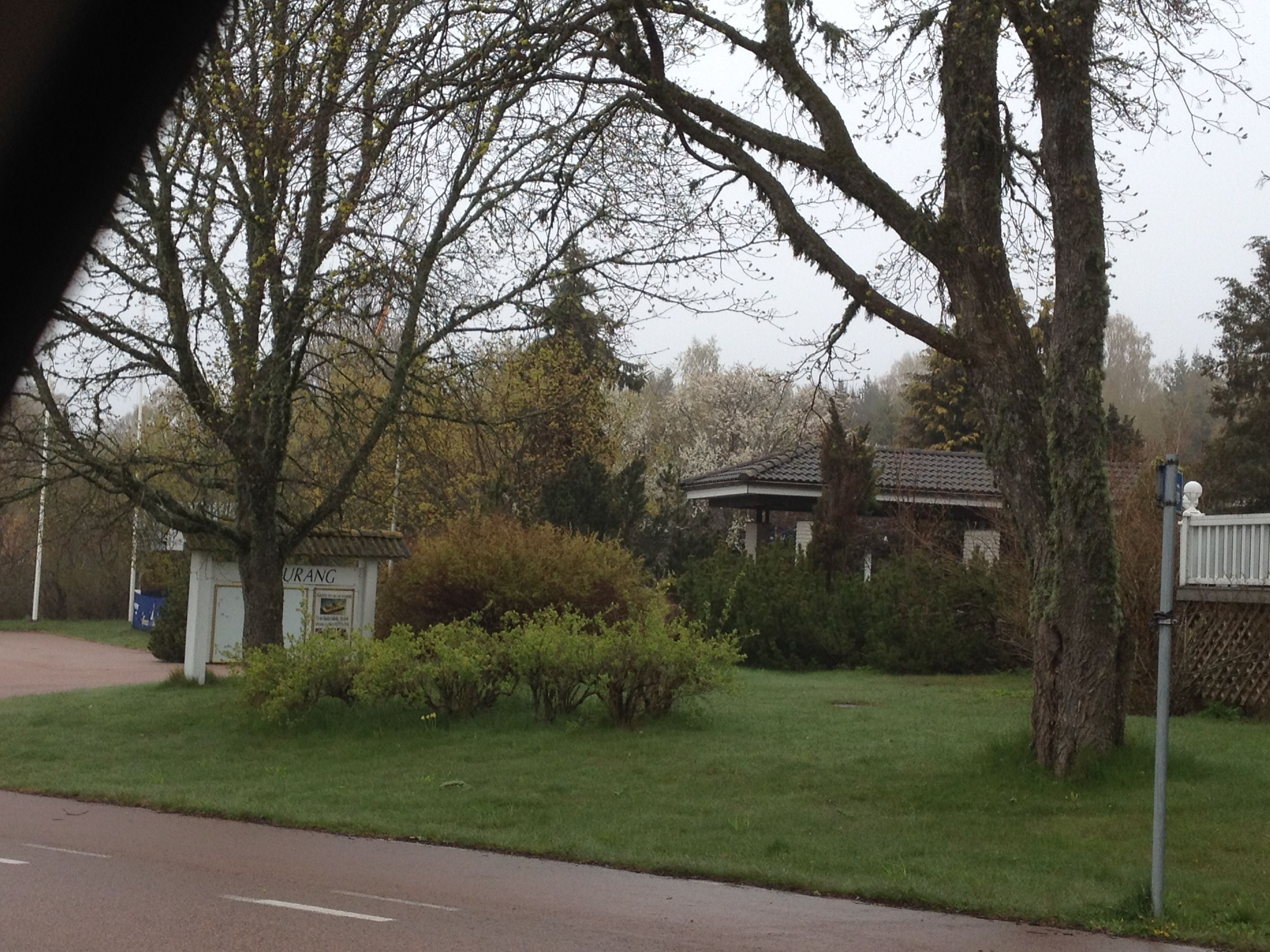 A park with a gazebo, a small building labeled 'URANG', and a house with a tiled roof.
