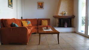 Villa, 3 Bedrooms, Beachfront | Living area | 32-inch flat-screen TV with satellite channels, TV, fireplace - Stavento - Villa Pounda (Aigialeia)