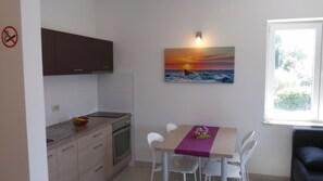 Deluxe Apartment, Balcony, Partial Sea View | In-room dining