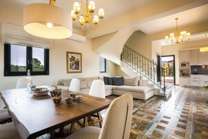 Pleiades Luxury Villa | Living area | Flat-screen TV