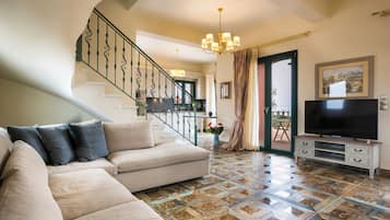 Pleiades Luxury Villa | Living area | 55-inch flat-screen TV with satellite channels, TV, DVD player