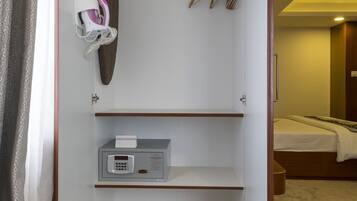 A walk-in closet with a shoe rack, a small heater, and a shoe shelf.