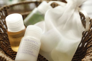A wicker basket containing Provinscia lavender conditioner and a bottle of Provinscia shower gel.