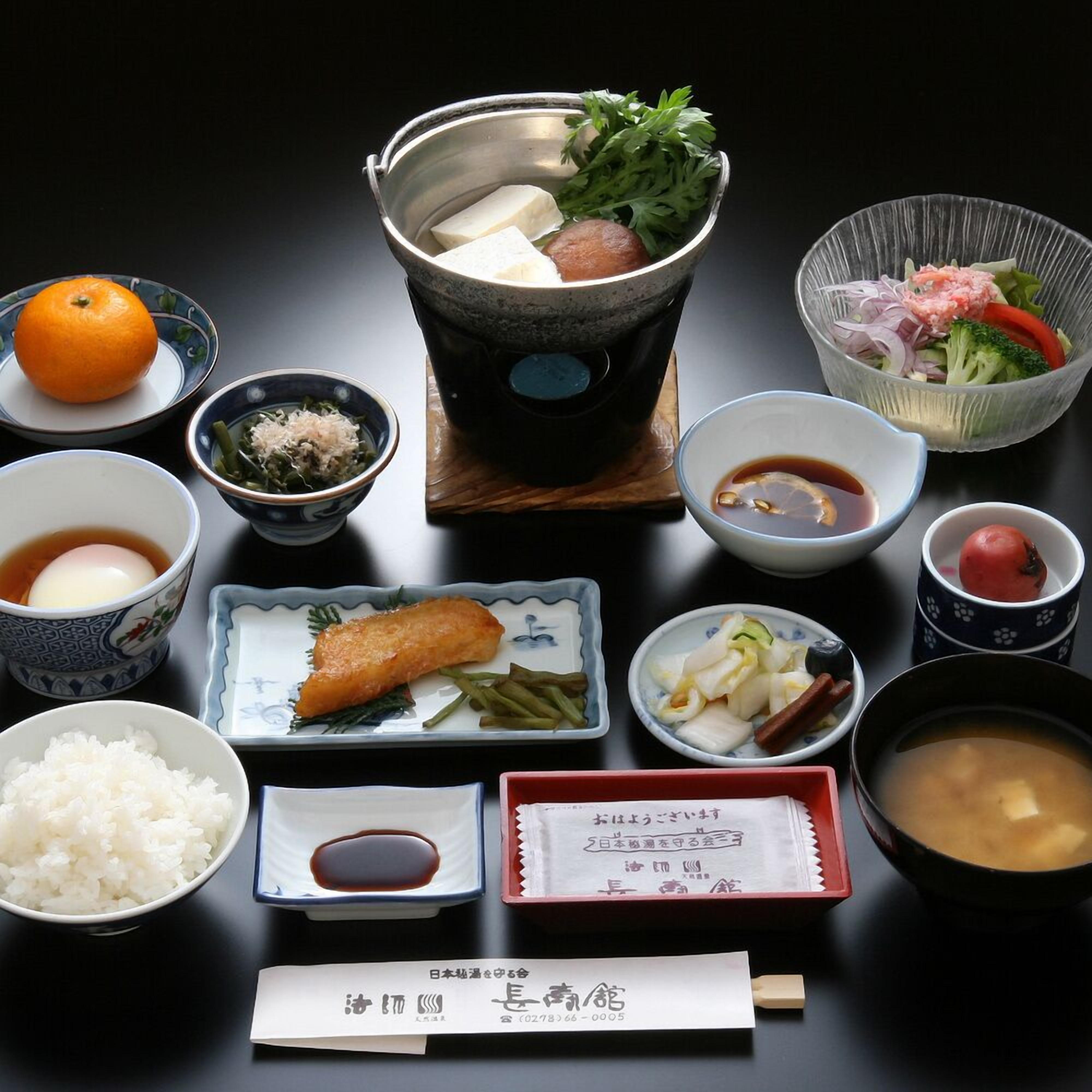 A traditional Japanese meal setup with various dishes and a teapot.