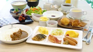 A breakfast table with various dishes including rice, eggs, and hot dogs. - Hotel Castle Plaza (Akashi)
