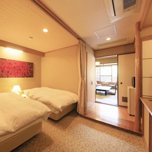 A hotel room with two beds, a nightstand, a lamp, a red abstract painting, and a view of the adjacent room. - Yugawara Ohnoya Ryokan (Atami)