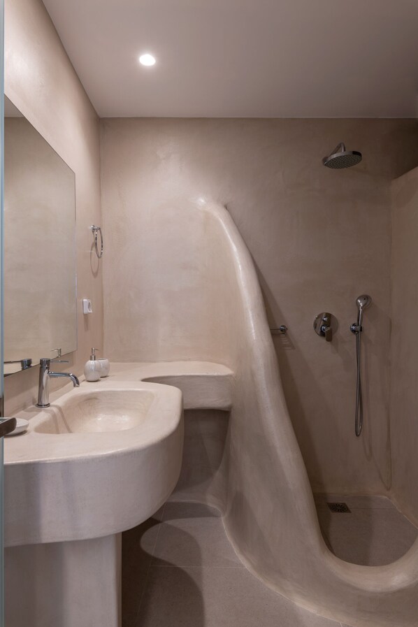 A modern bathroom with a curved shower enclosure, a double sink vanity, and a large mirror. - Mykonos Divino (Mykonos)