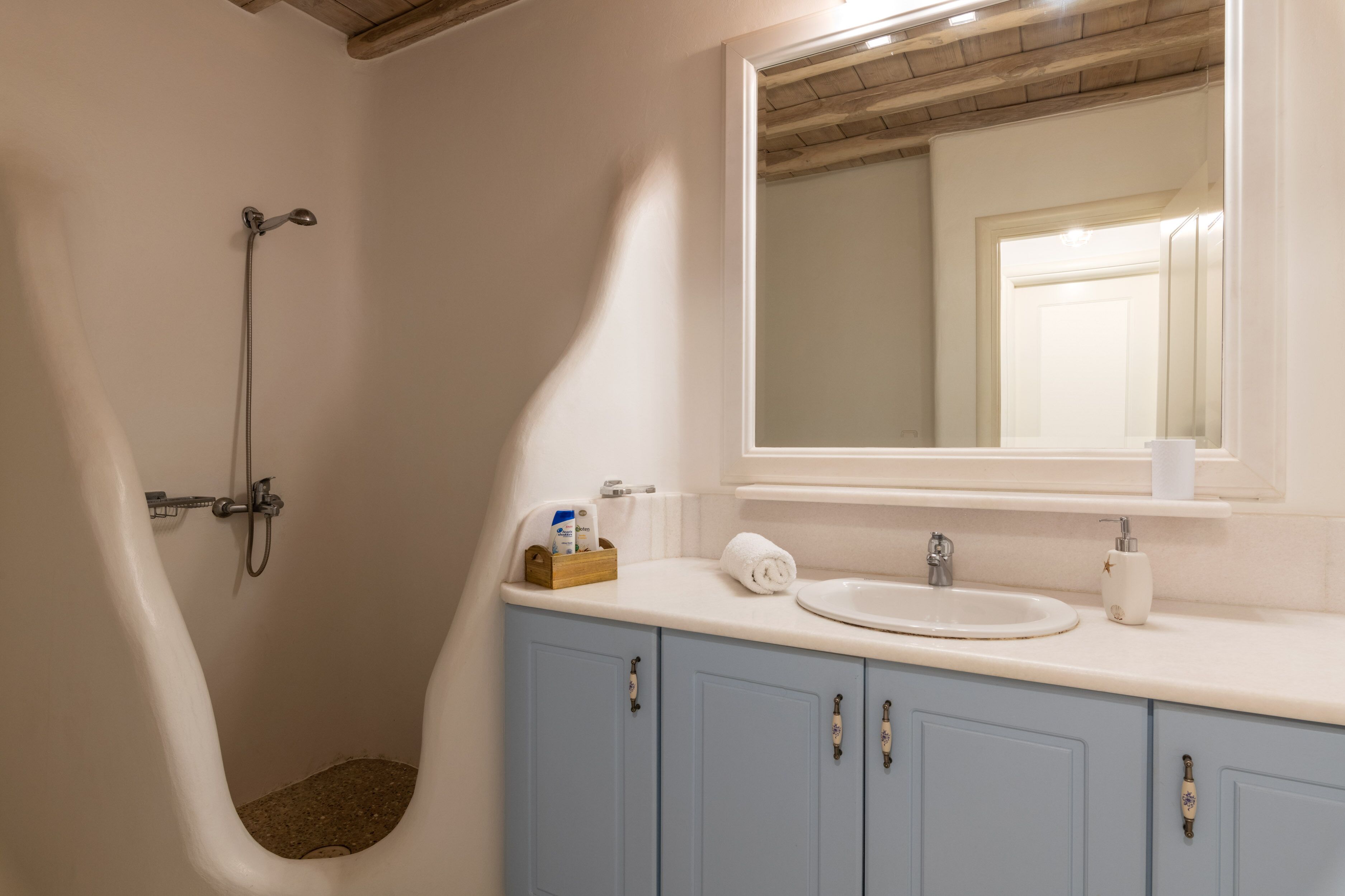 A bathroom with a bathtub, a sink, and a mirror.