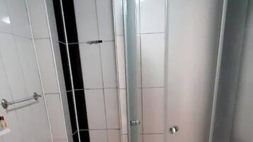 A bathroom with a shower, toilet, and sink.