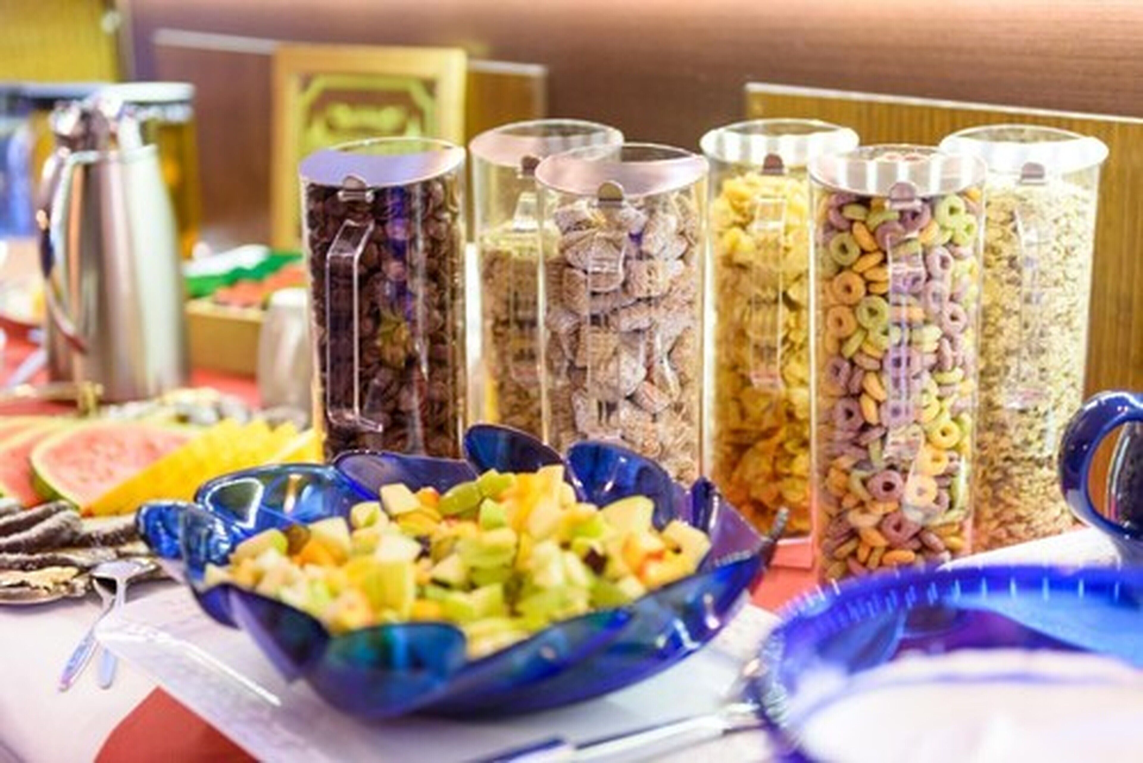 A buffet table with various food items and containers.
