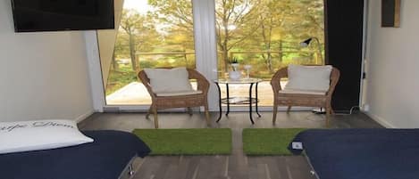 Suite, balcón | Área de sala de estar | Televisión