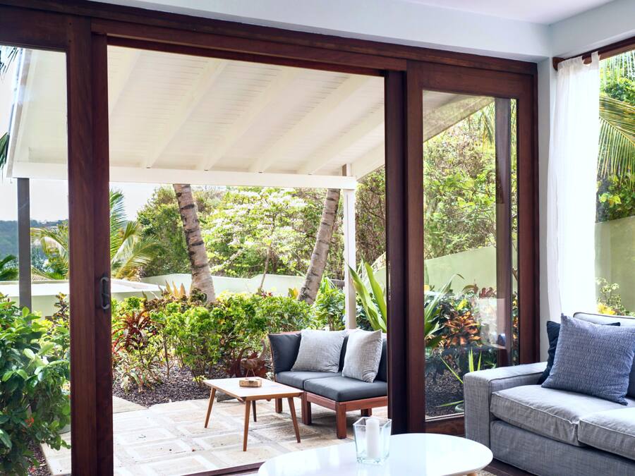 A modern outdoor living area with a sofa, a coffee table, and a dining table.