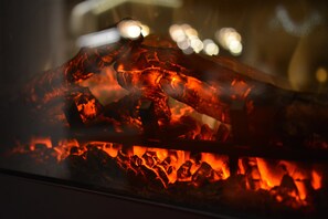 A close-up of glowing charcoal coals. - Hotel Ylläsrinne (Kolari)