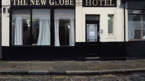 A building with a sign reading "The New Globe Hotel". - New Globe Hotel (London)