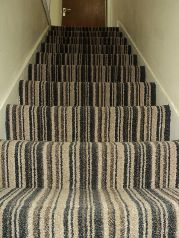 A carpeted staircase with a striped pattern. - New Globe Hotel (London)