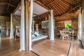 A wooden interior with a sofa, a chair, and a desk.