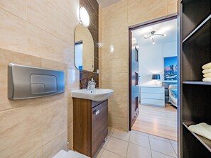 Een moderne badkamer met een wastafel, spiegel en badkamermeubel.