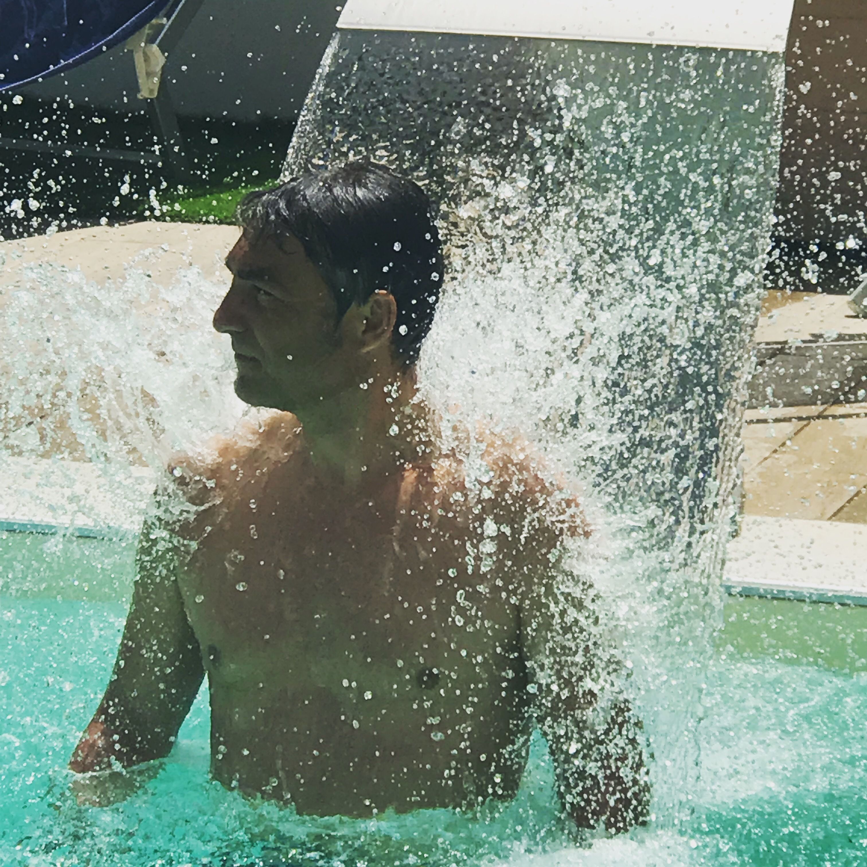 outdoor pool, a waterfall pool, pool loungers