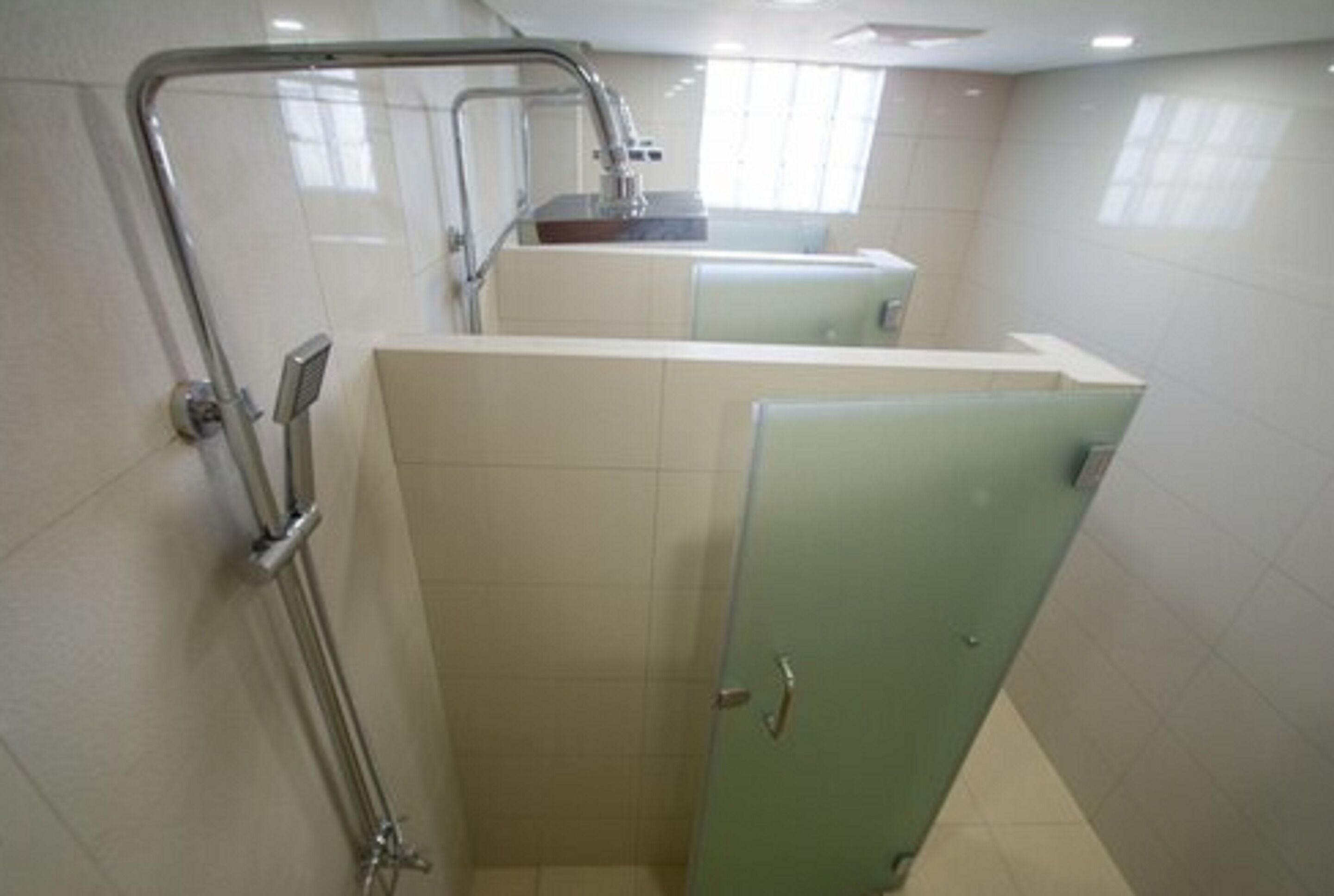 A bathroom with a shower, a sink, and a toilet.