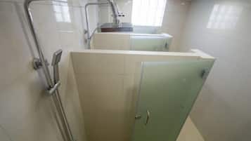 A bathroom with a shower, a sink, and a toilet.