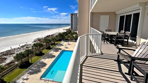 A balcony with a pool, overlooking a beach and ocean. - 🐋 A day at the beach restores the soul🌊Call Today and Save! (Orange Beach)