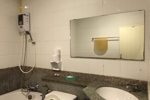 A bathroom with a shower, toilet, and sink.
