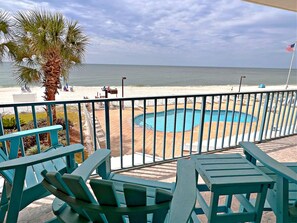 A poolside area with a view of the beach and ocean.