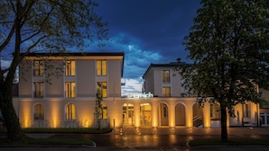 A hotel with a modern facade, multiple balconies, and a well-lit entrance. - Seereich Hotel & Pension (Lindau)