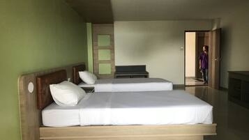 A double bed with a wooden headboard and a nightstand.