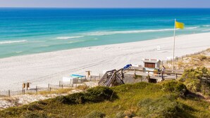 A beach with a lifeguard tower, a wooden walkway, and a sandy shore. - ⭐Gulf Views | Walk2Beach | Balcony | 2BR Summit at Tops'l 714⭐ (Miramar Beach)