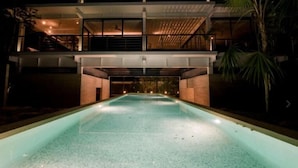 A modern building with a swimming pool in front. - TAO Modern Retreat (Akumal)